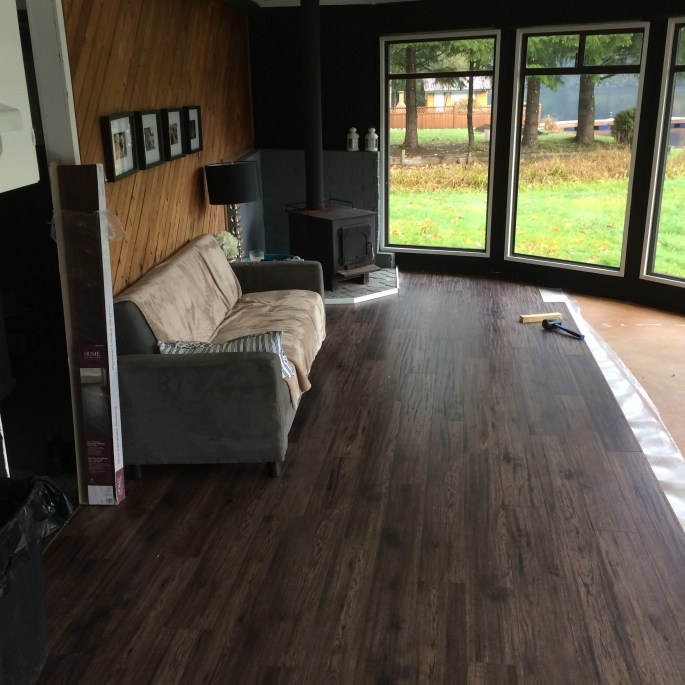 Handyman Rob Brown installs wood laminate flooring at a home in Vancouver, BC, Canada.