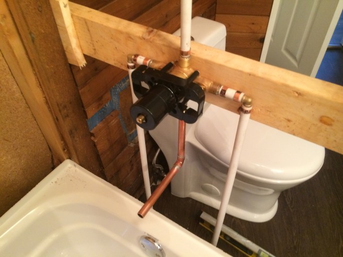 Handyman Rob Brown delivers renovates bathrooms in Vancouver, BC, Canada. He carefully measures, cuts and installs wood, tiles, pipes and basic plumbing for toilets and sinks.