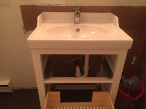 Handyman Rob renovates bathrooms in Vancouver, BC. He carefully measures, cuts and installs wood, tiles and pipes for sinks and faucets.