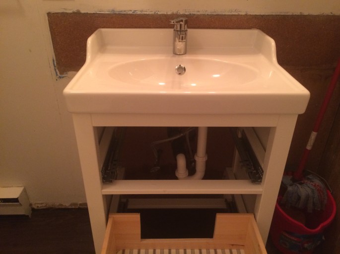 Handyman Rob Brown renovates bathrooms in Vancouver, BC. He carefully measures, cuts and installs wood, tiles and pipes for sinks and faucets.